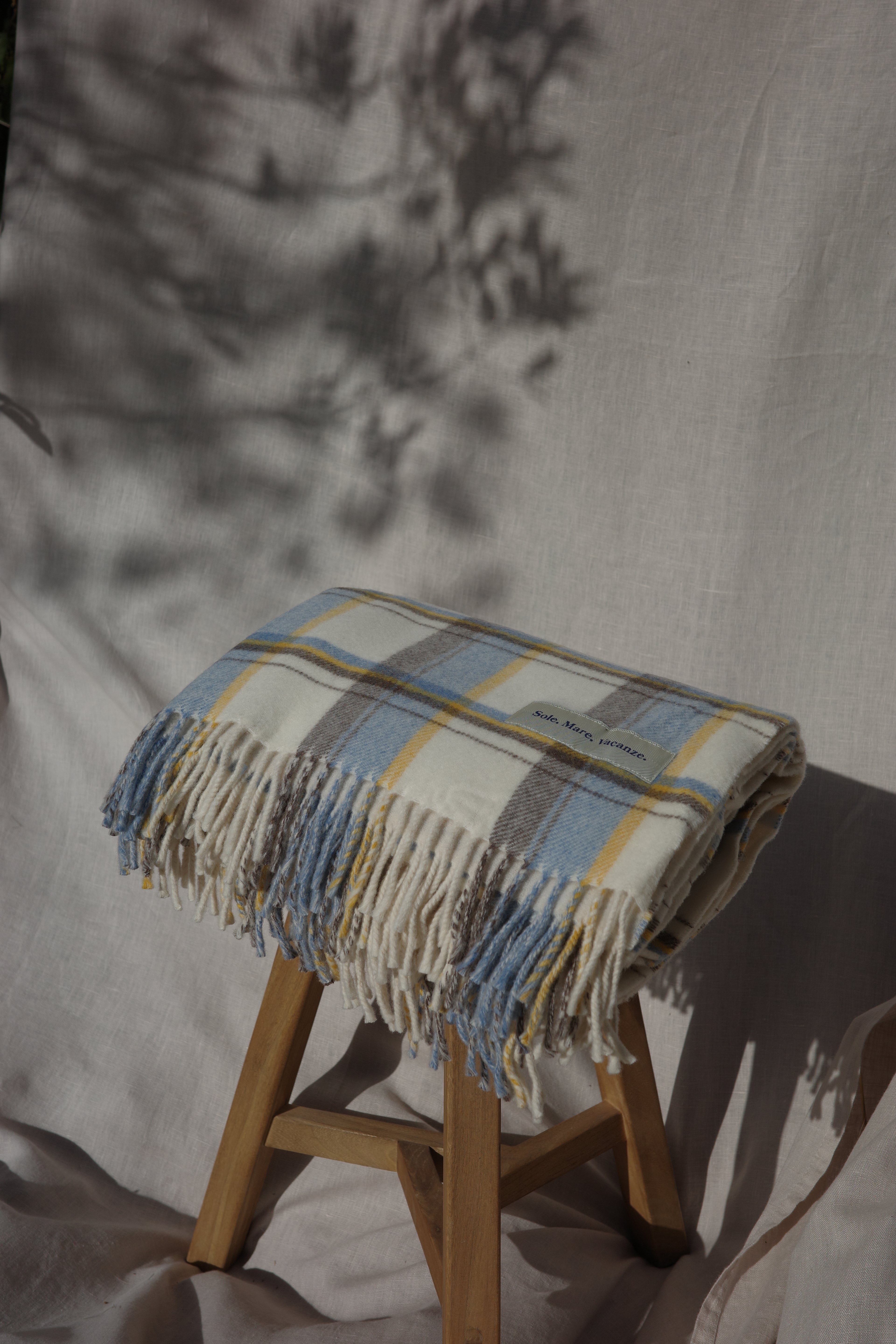 coperta di lana, coperta a quadri, coperta Made in Italy, fibre naturali, eleganza mediterranea, design senza tempo, accessorio di lusso per la casa.