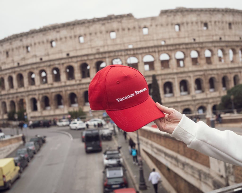 Vacanze Romane red baseball cap in Rome. Colosseum, Roma. Valentines in Rome, Italy.